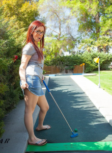 Busty redhead in jeans skirt playing putt putt mini golf